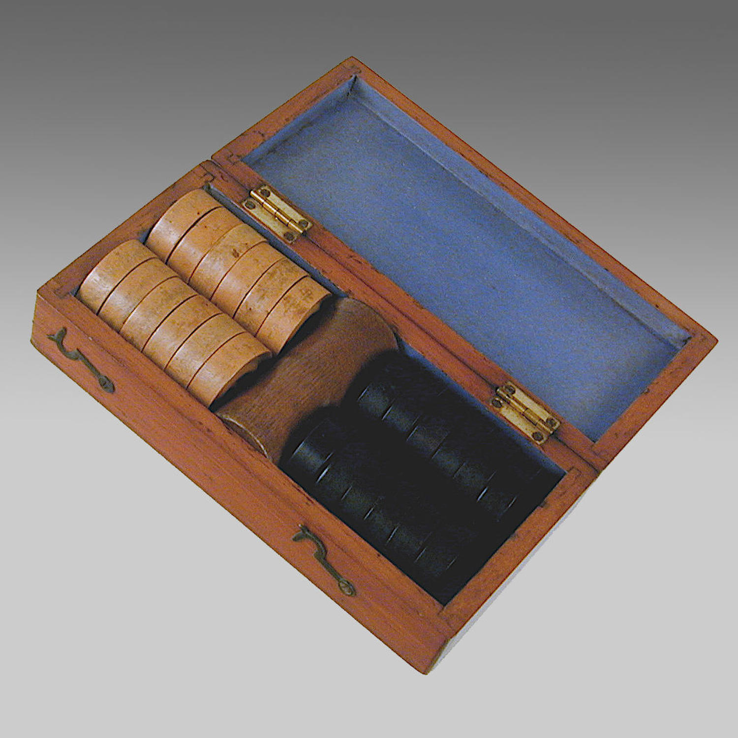 Antique mahogany boxed set of boxwood and ebony draughtsmen
