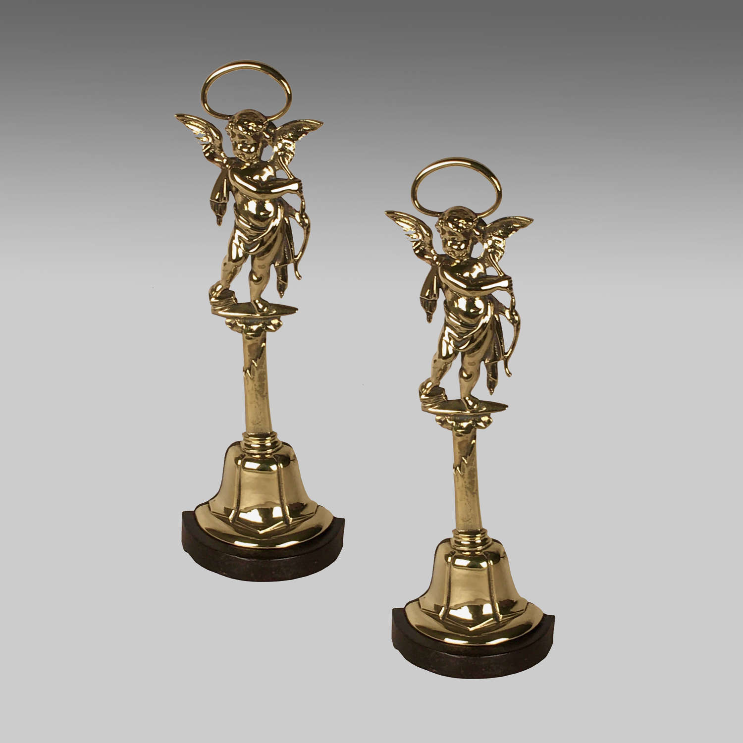 A pair of brass and cast iron doorstops