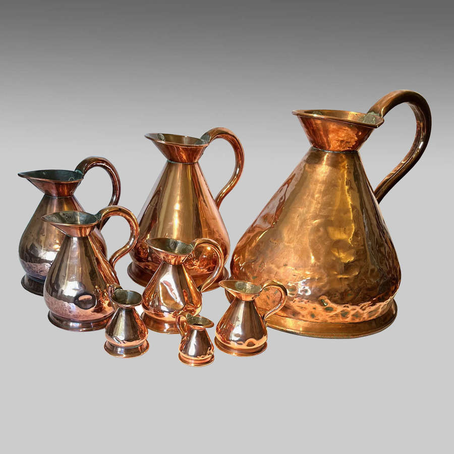 19th century graduated set of eight copper spirit measures