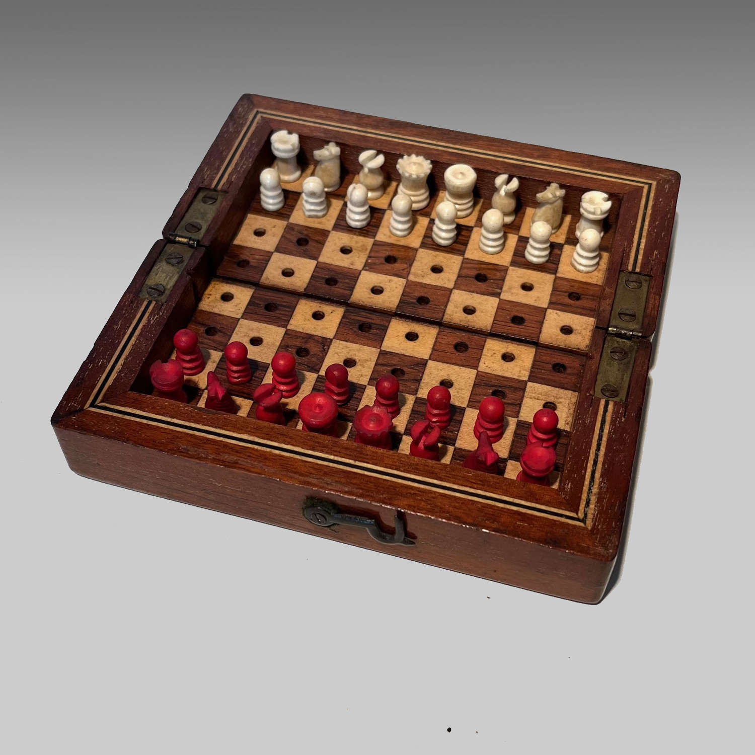 Small mahogany cased travelling chess set